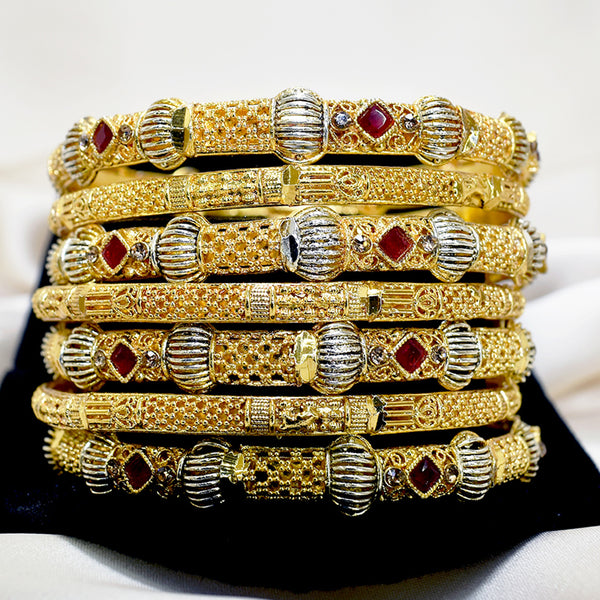Radiant Glamour: Gold-Plated Bangles with Red Stone